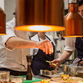 chef putting garnishing on a dish