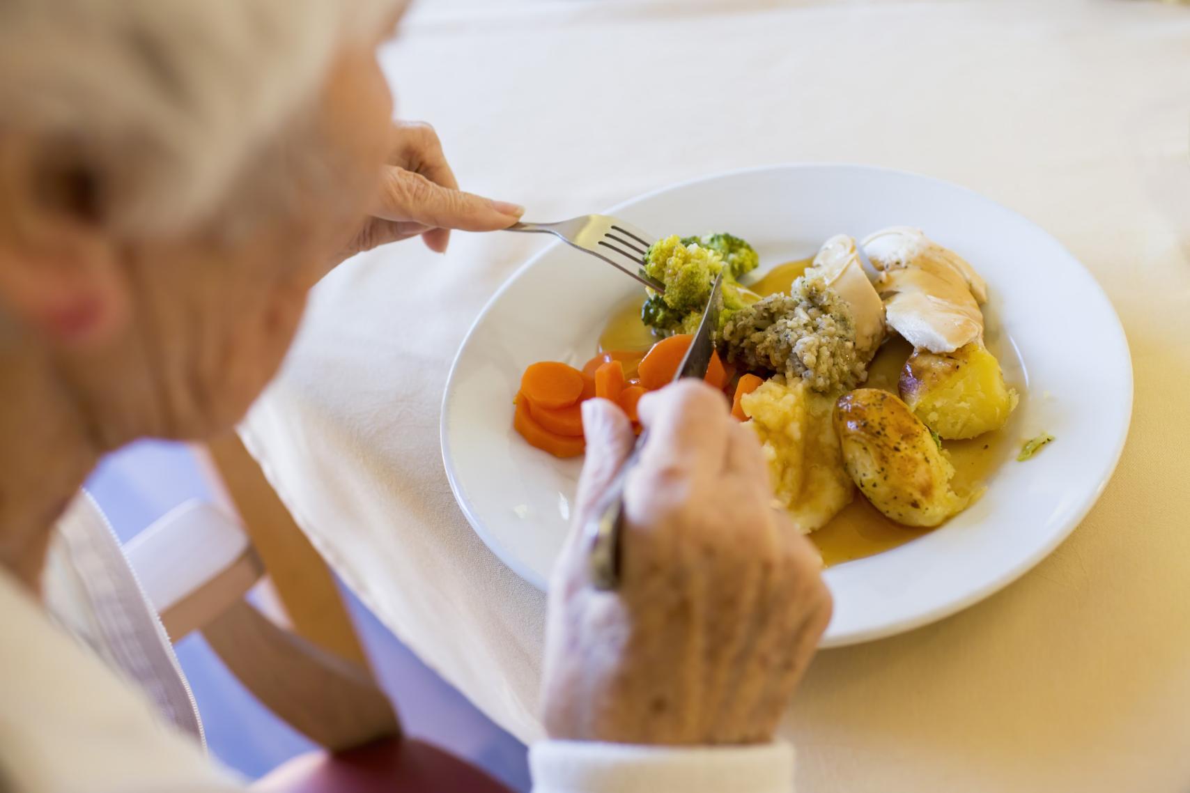 Elderly Woman Eating Roast Dinner