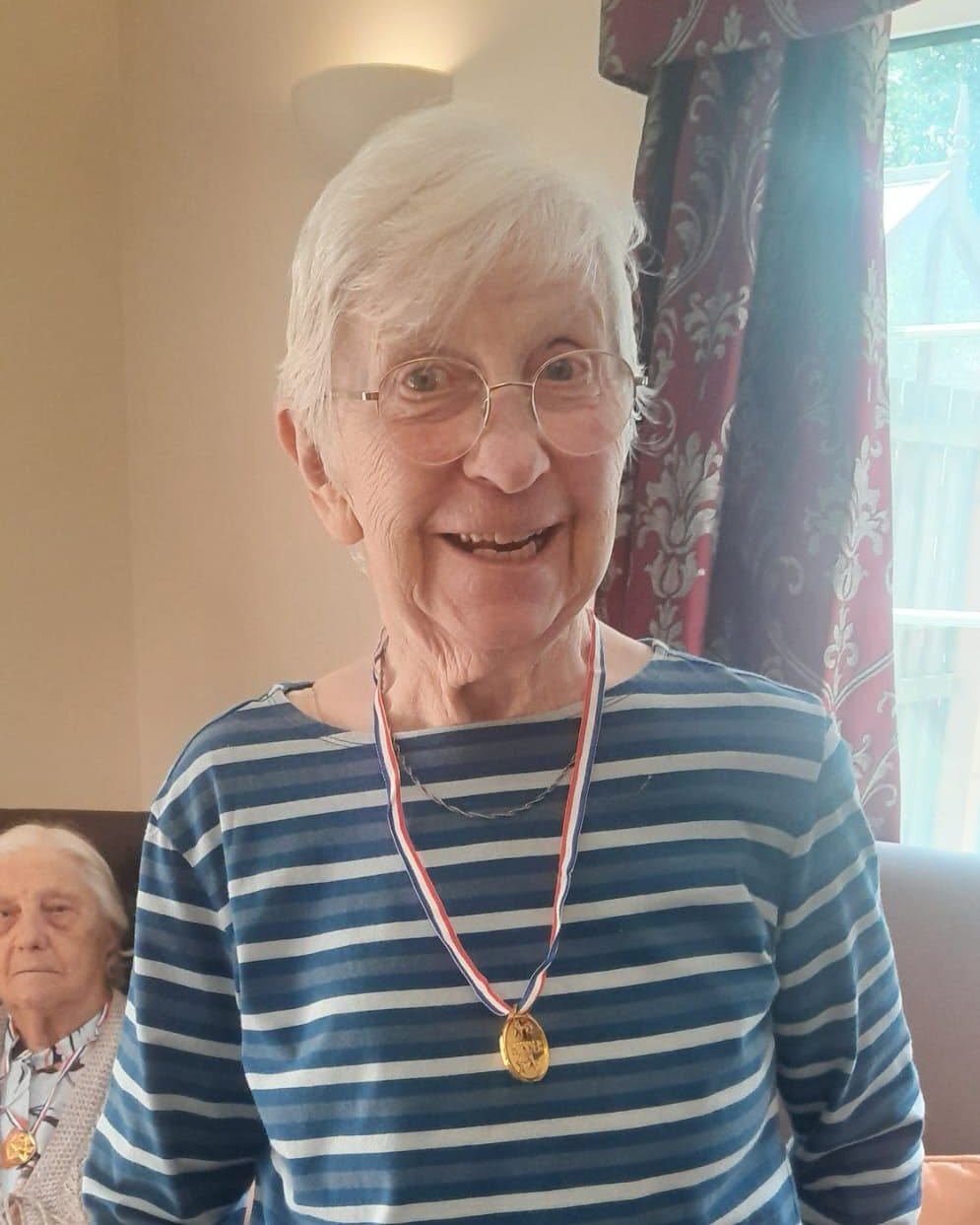 an older lady wearing a medal
